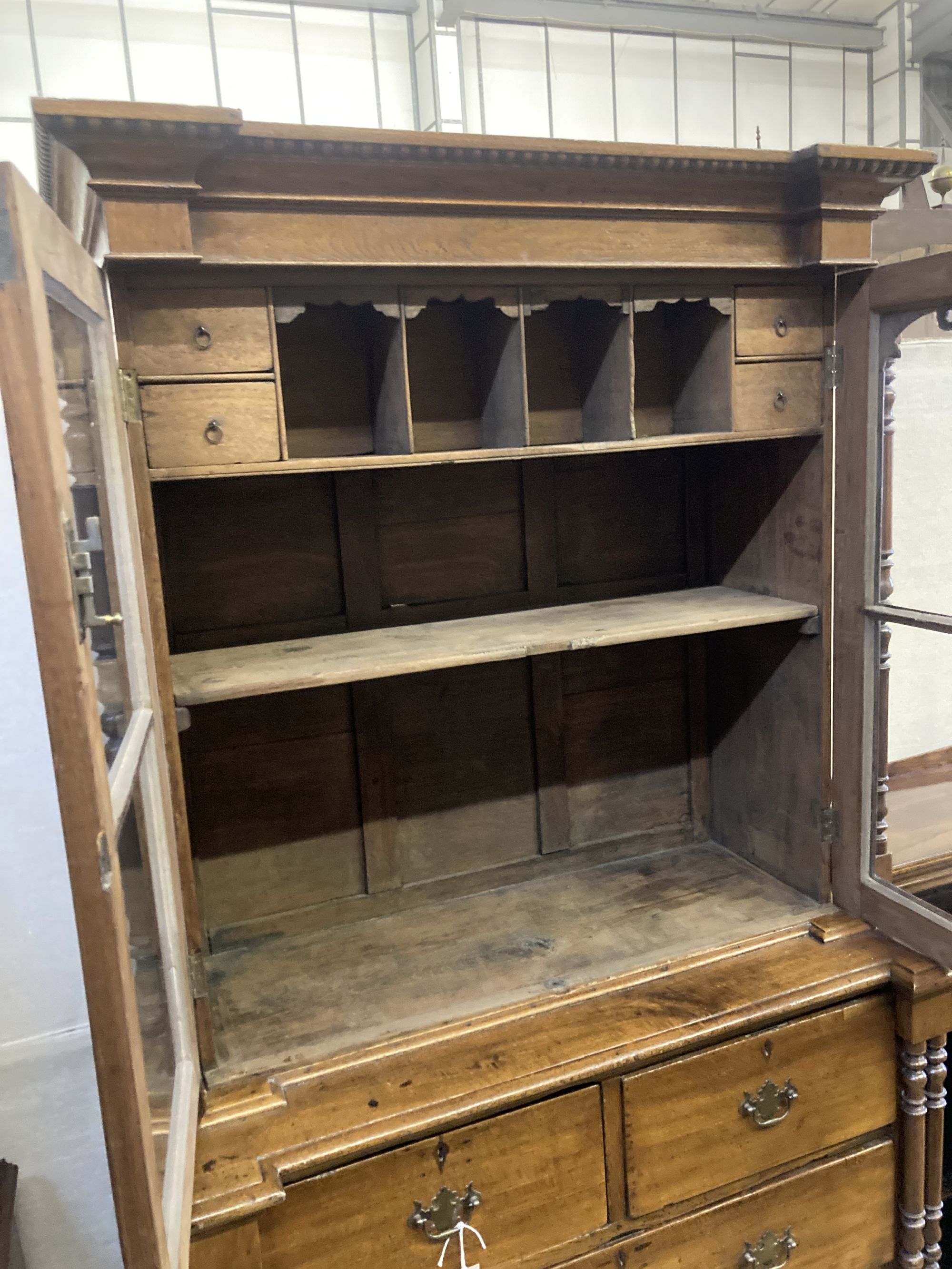 A 19th century Continental oak glazed cabinet on chest, width 104cm, depth 51cm, height 200cm